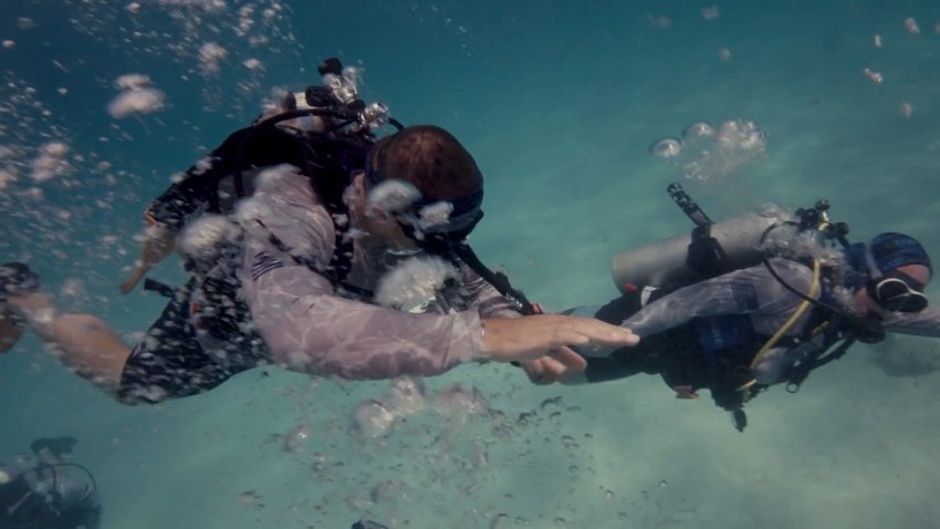 Two divers swimming in the ocean.